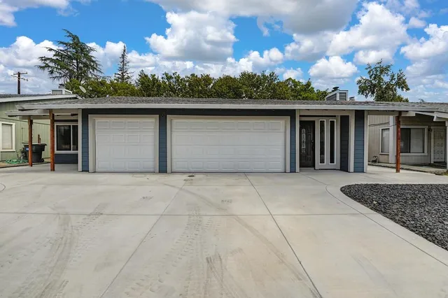 a kitchen with a sink a refrigerator and a stove top oven with wooden floor