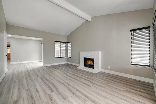 a kitchen with a sink window and cabinets
