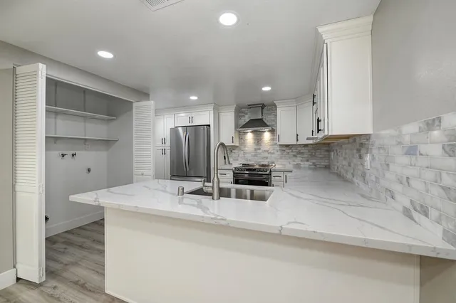 a view of a room with wooden floor and a ceiling fan