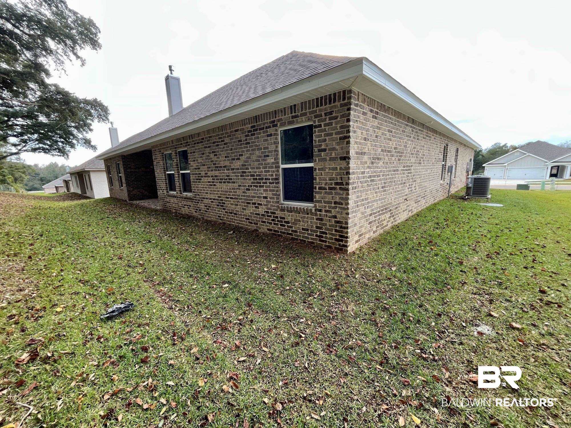 334 Barndling Street Fairhope, AL 36532 - Photo 33 of 34 View of side of property featuring cooling unit and a lawn