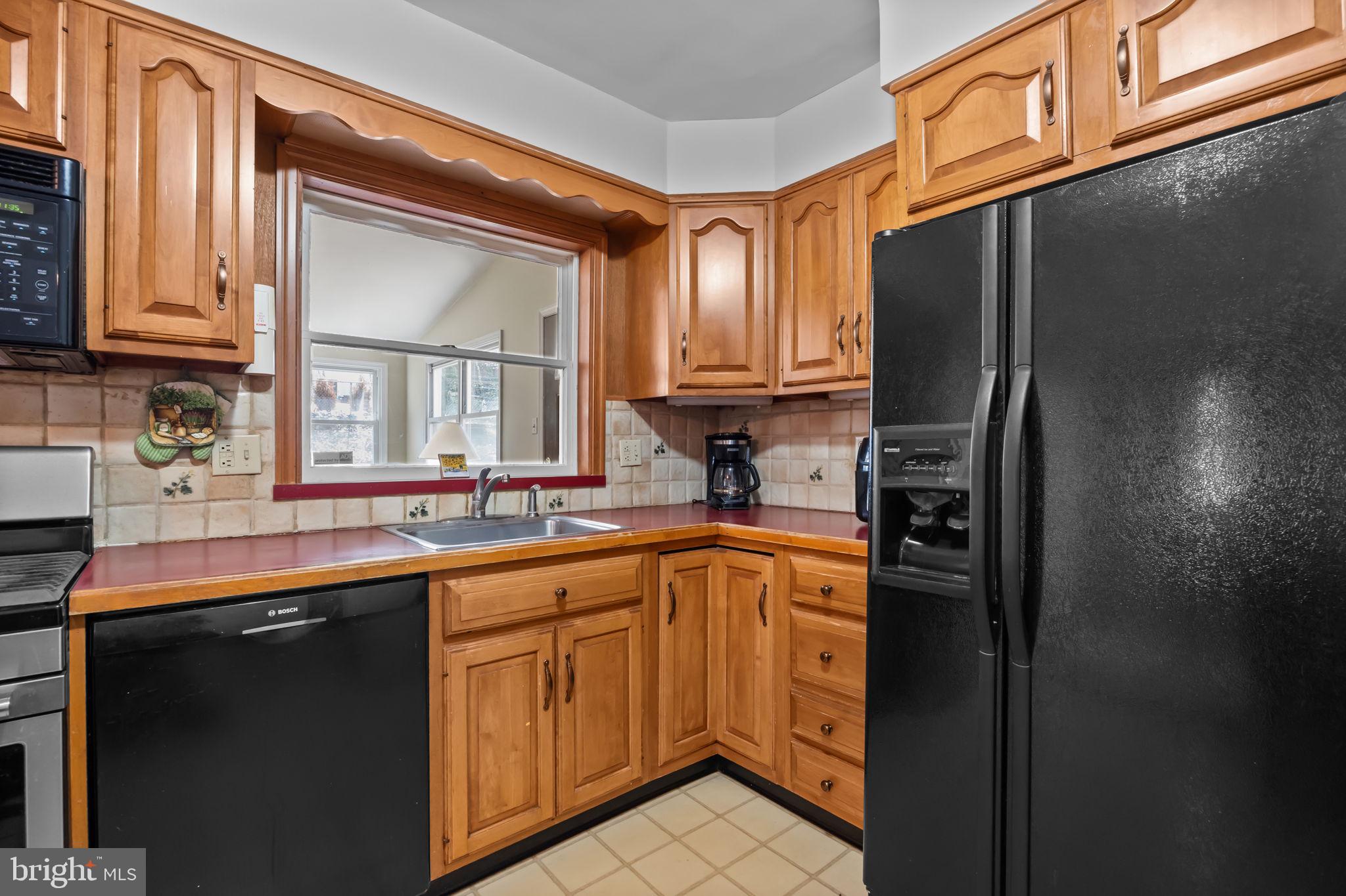 211 Rolling Hill Road Elkins Park, PA 19027 - Photo 12 of 41 a kitchen with stainless steel appliances granite countertop a refrigerator and a sink