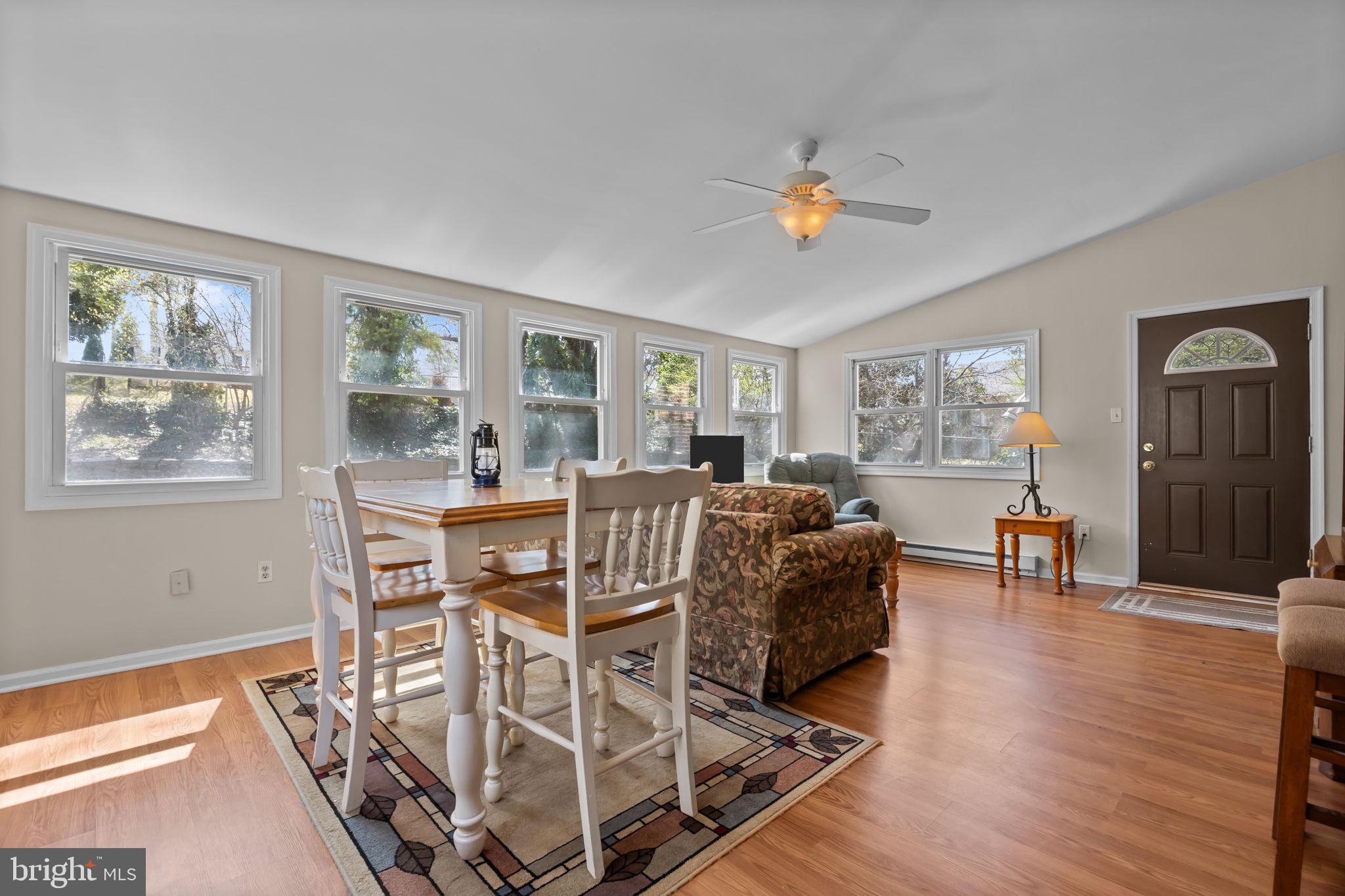 211 Rolling Hill Road Elkins Park, PA 19027 - Photo 15 of 41 a living room with furniture a dining table and a window