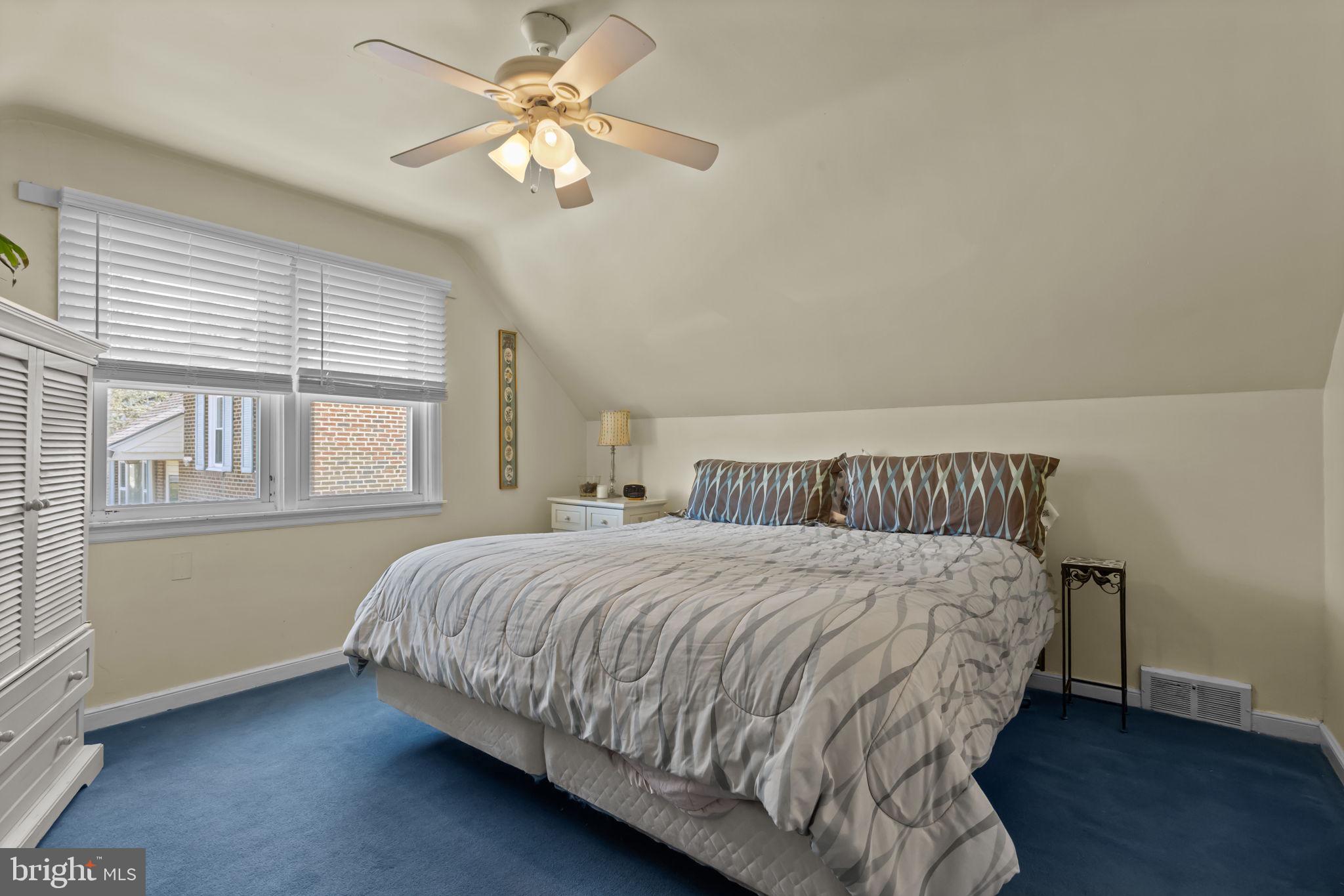 211 Rolling Hill Road Elkins Park, PA 19027 - Photo 23 of 41 a bedroom with a bed chandelier and a window