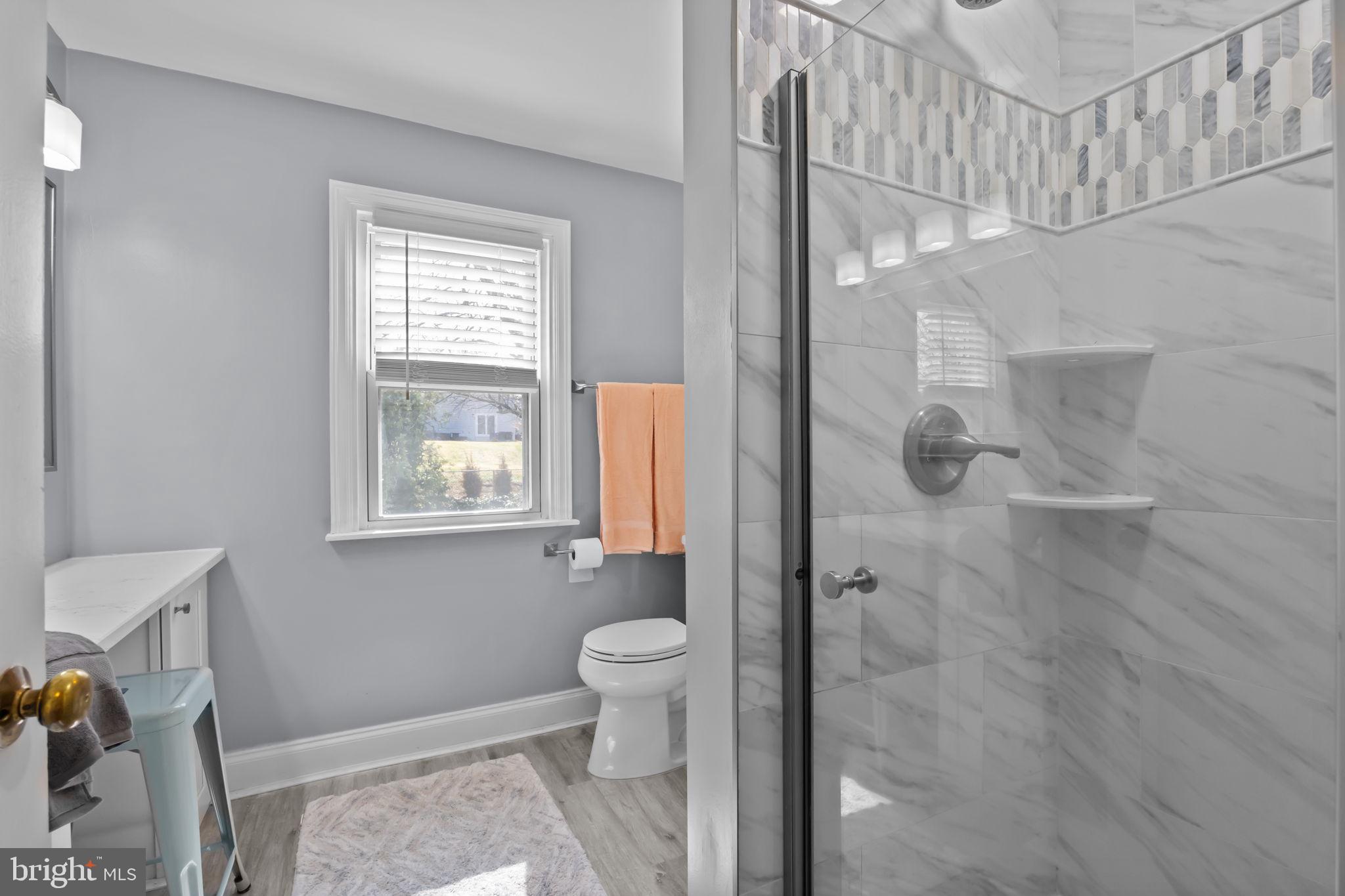 211 Rolling Hill Road Elkins Park, PA 19027 - Photo 25 of 41 a bathroom with a granite countertop sink a toilet and shower