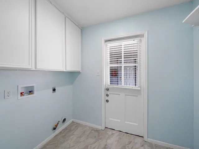 a view of storage and utility room with closet