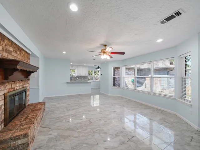 a view of an empty room with a kitchen