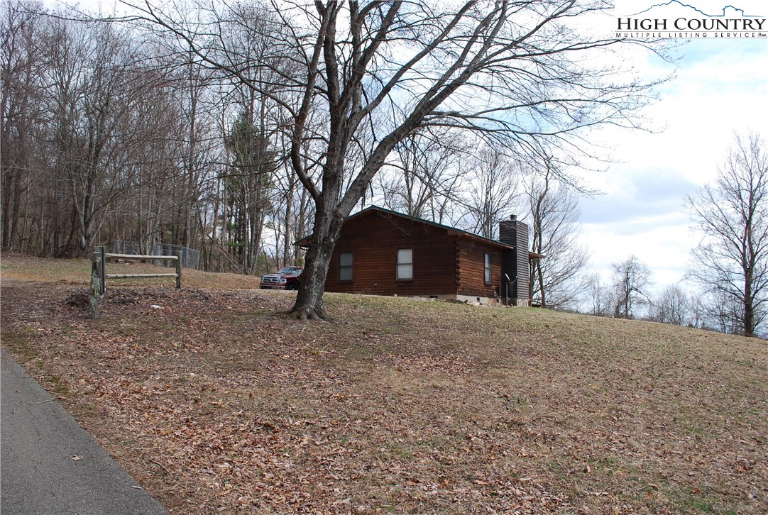 238 Misty Ridge Road Millers Creek, NC 28651 - Photo 12 of 22 a backyard of a house with lots of green space