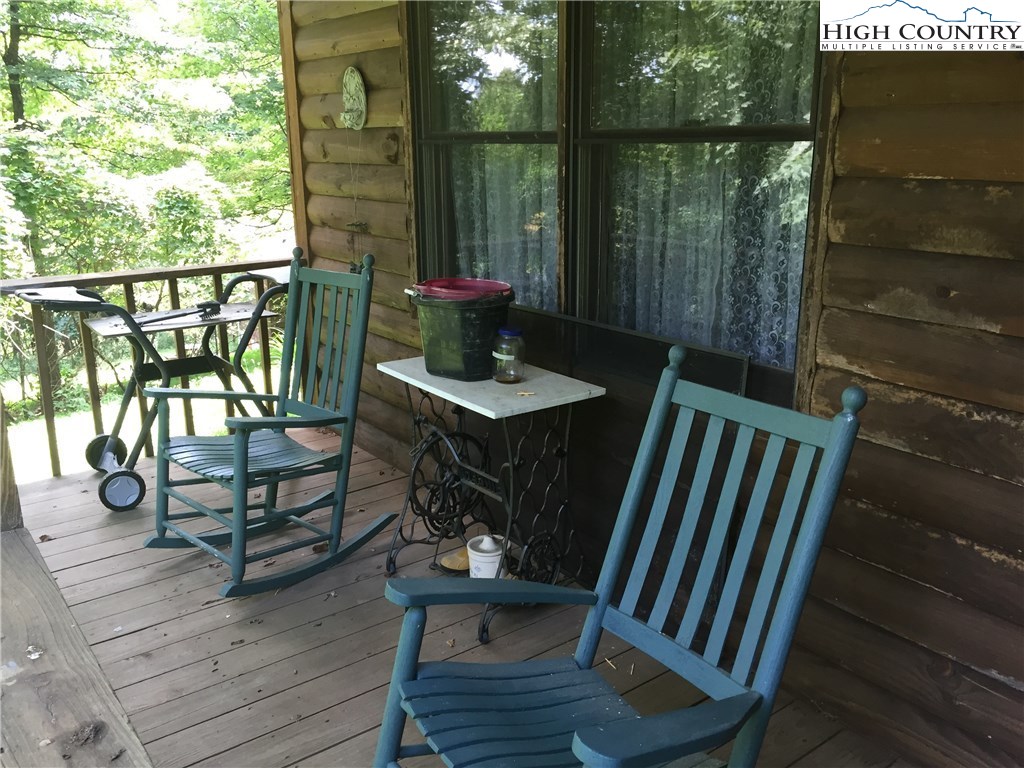 238 Misty Ridge Road Millers Creek, NC 28651 - Photo 3 of 22 a view of balcony with chairs and wooden floor