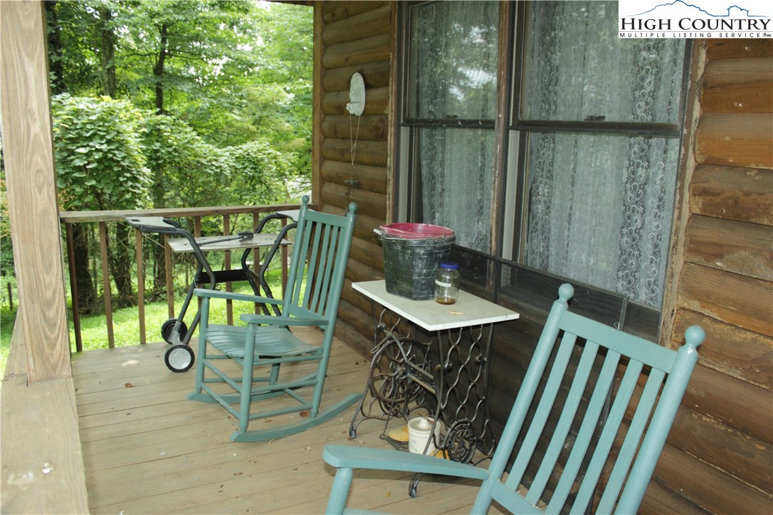 238 Misty Ridge Road Millers Creek, NC 28651 - Photo 7 of 22 a balcony with table and chairs