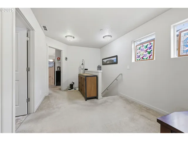 a view of a livingroom with furniture and an empty room