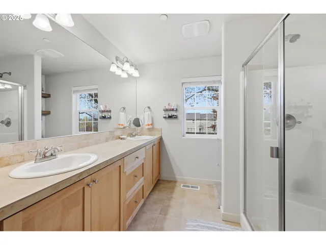 a bathroom with a sink double vanity and a mirror