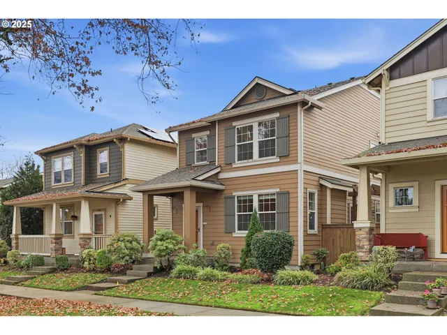 a view of a white house next to a yard
