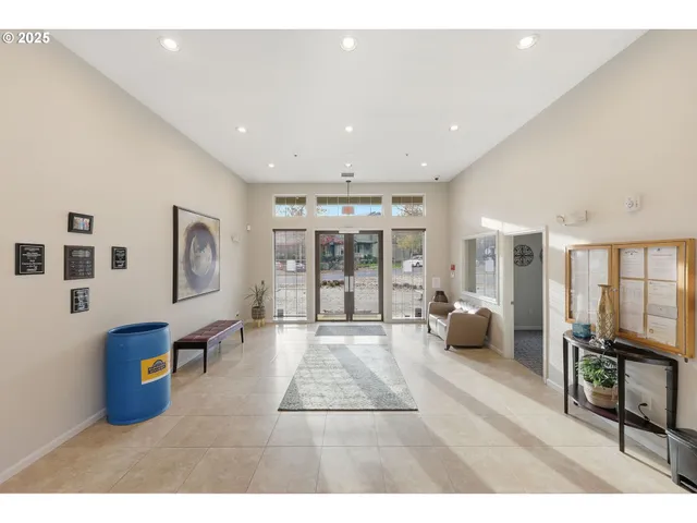 a living room with furniture large window and flat screen tv