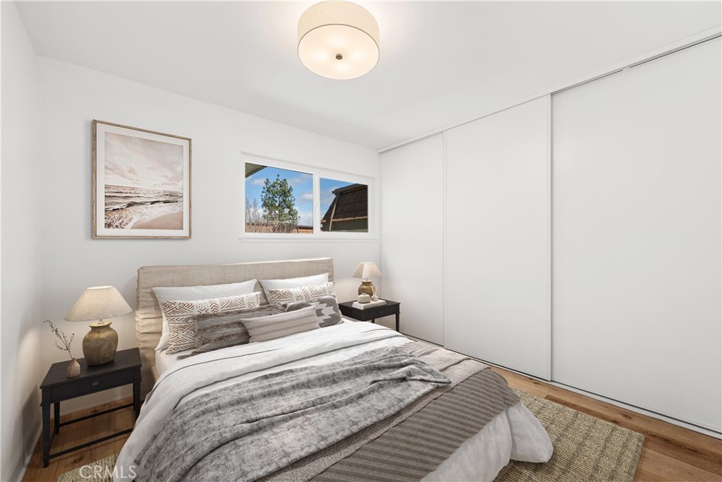 10179 Larwin Avenue, Unit 5 Chatsworth, CA 91311 - Photo 17 of 53 a bedroom with a bed and a painting on the wall