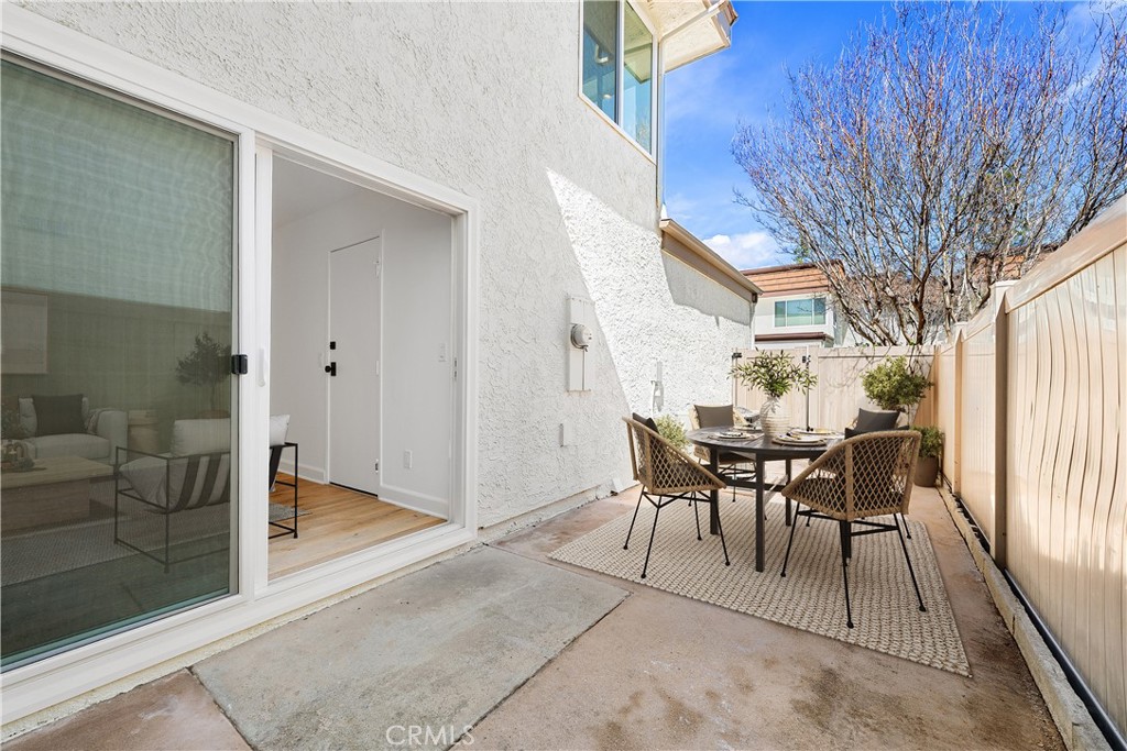 10179 Larwin Avenue, Unit 5 Chatsworth, CA 91311 - Photo 19 of 53 a view of a patio with table and chairs and potted plants