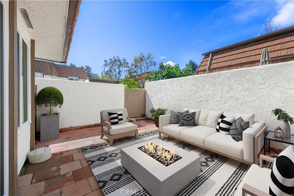 10179 Larwin Avenue, Unit 5 Chatsworth, CA 91311 - Photo 20 of 53 a view of a patio with couches and potted plants