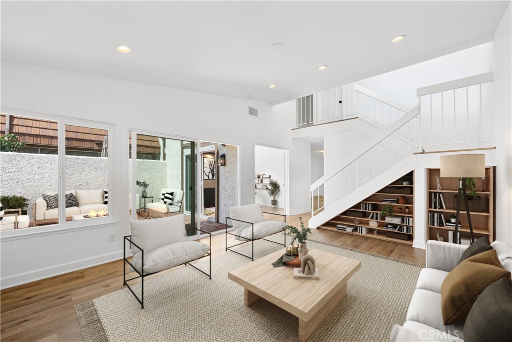 10179 Larwin Avenue, Unit 5 Chatsworth, CA 91311 - Photo 2 of 53 a living room with furniture and wooden floor