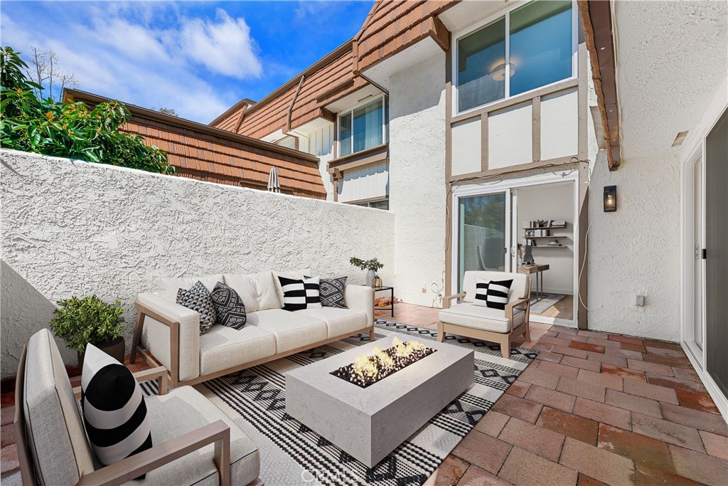 10179 Larwin Avenue, Unit 5 Chatsworth, CA 91311 - Photo 21 of 53 a view of a dinning table and chair in the patio