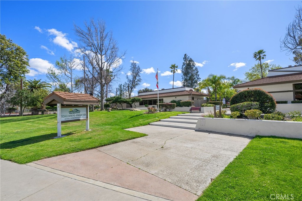 10179 Larwin Avenue, Unit 5 Chatsworth, CA 91311 - Photo 29 of 53 a front view of a house with garden and a yard