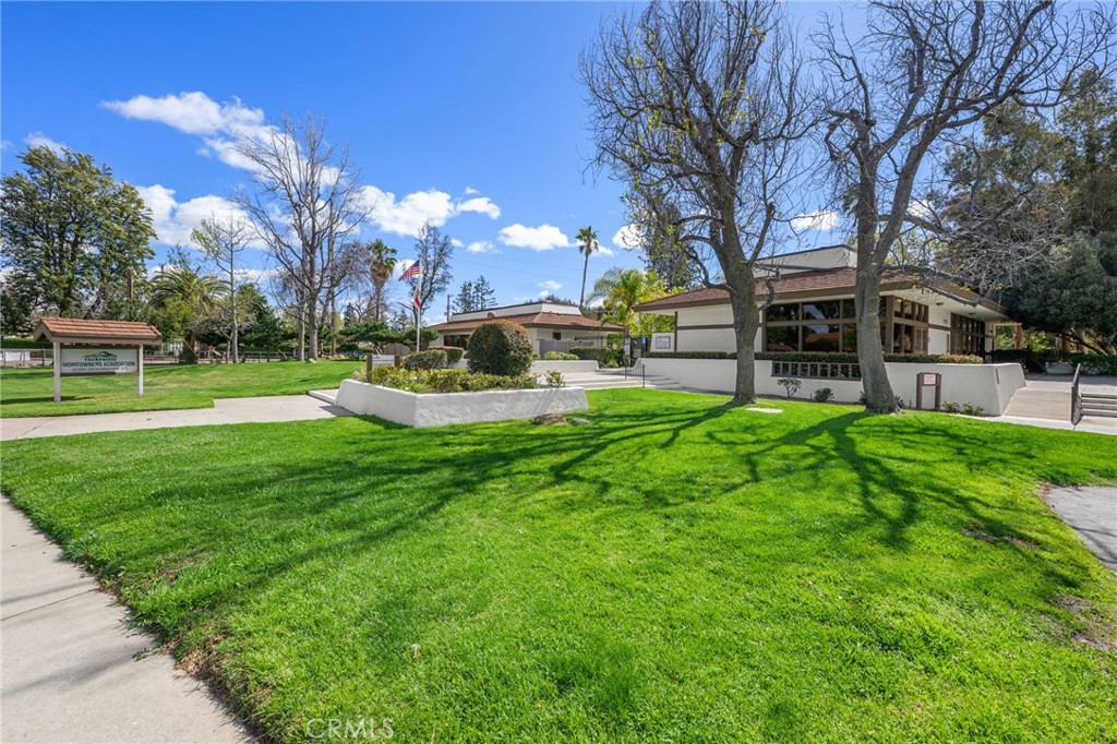 10179 Larwin Avenue, Unit 5 Chatsworth, CA 91311 - Photo 32 of 53 a view of a house with a big yard and large trees