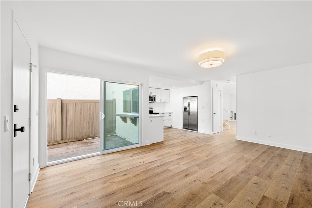 10179 Larwin Avenue, Unit 5 Chatsworth, CA 91311 - Photo 44 of 53 a view of a big room with wooden floor and windows