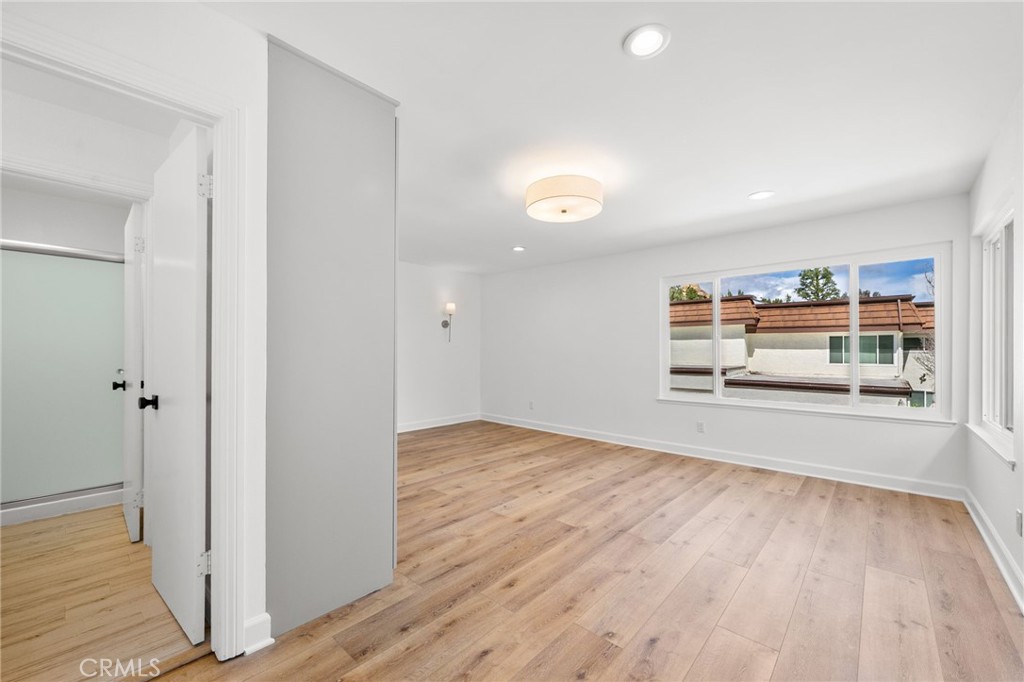 10179 Larwin Avenue, Unit 5 Chatsworth, CA 91311 - Photo 49 of 53 a view of empty room with wooden floor