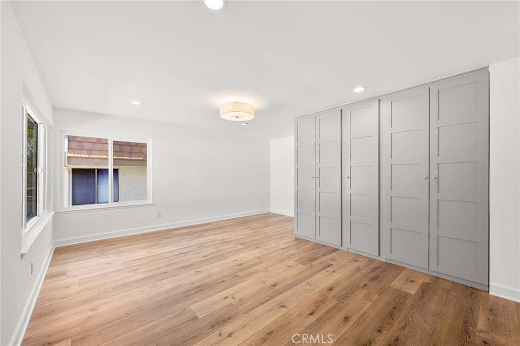 10179 Larwin Avenue, Unit 5 Chatsworth, CA 91311 - Photo 50 of 53 a view of empty room with wooden floor and fan