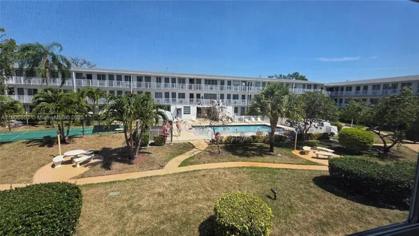 a view of a swimming pool with outdoor seating and plants