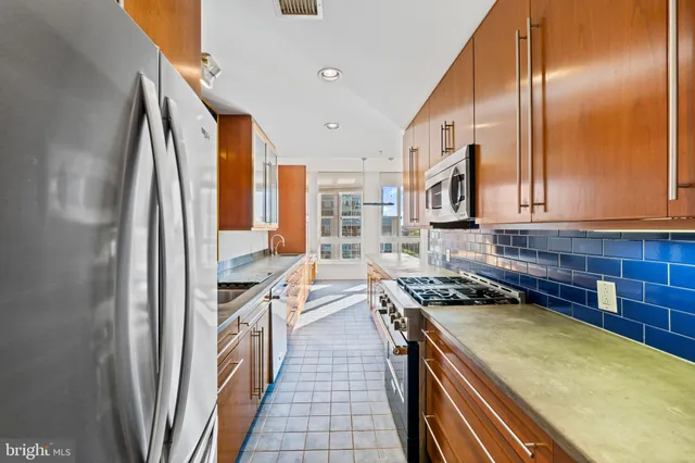 a kitchen with stove and cabinets