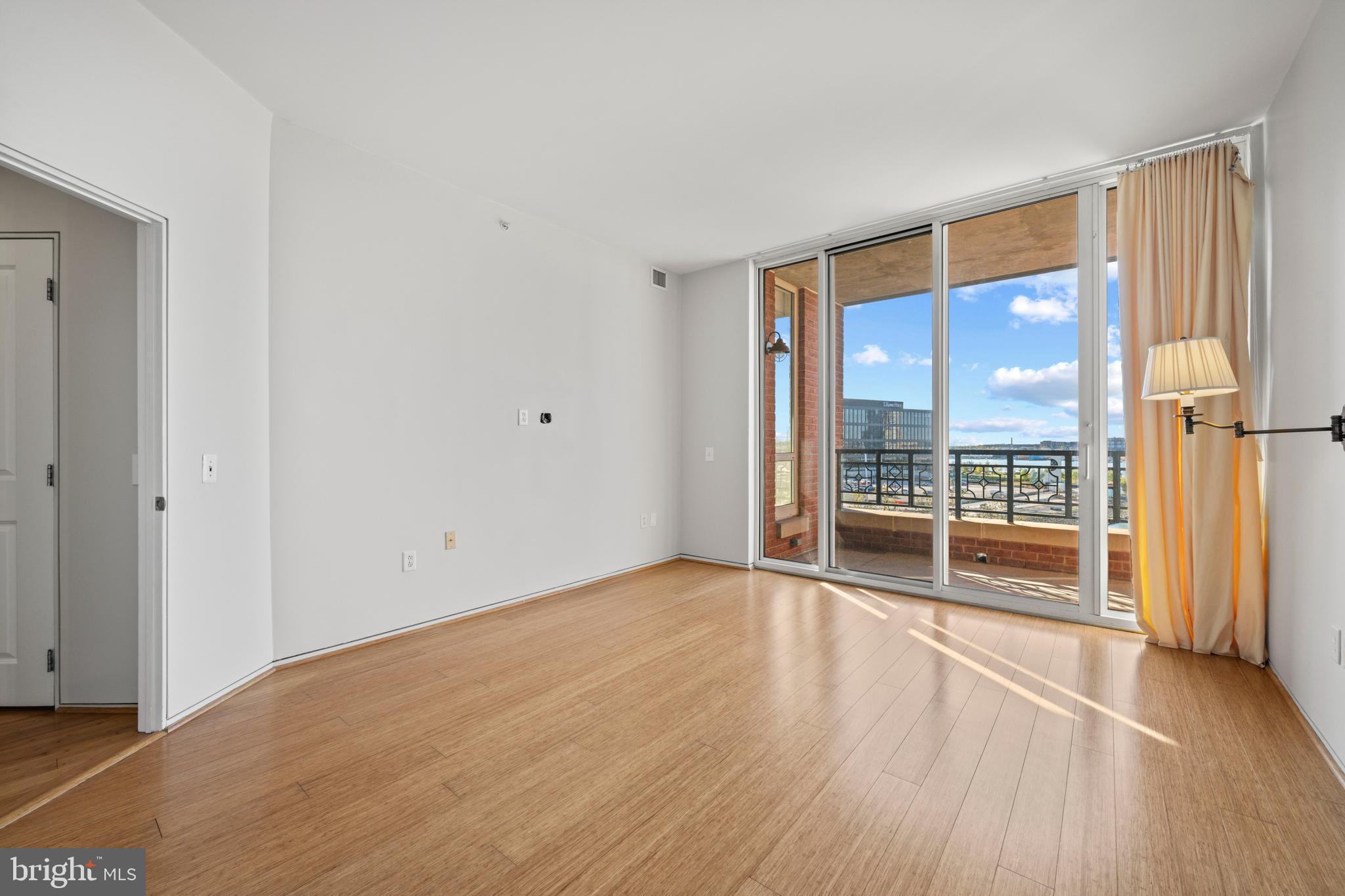 717 President Street, Unit 504 Baltimore, MD 21202 - Photo 28 of 29 an empty room with wooden floor and windows