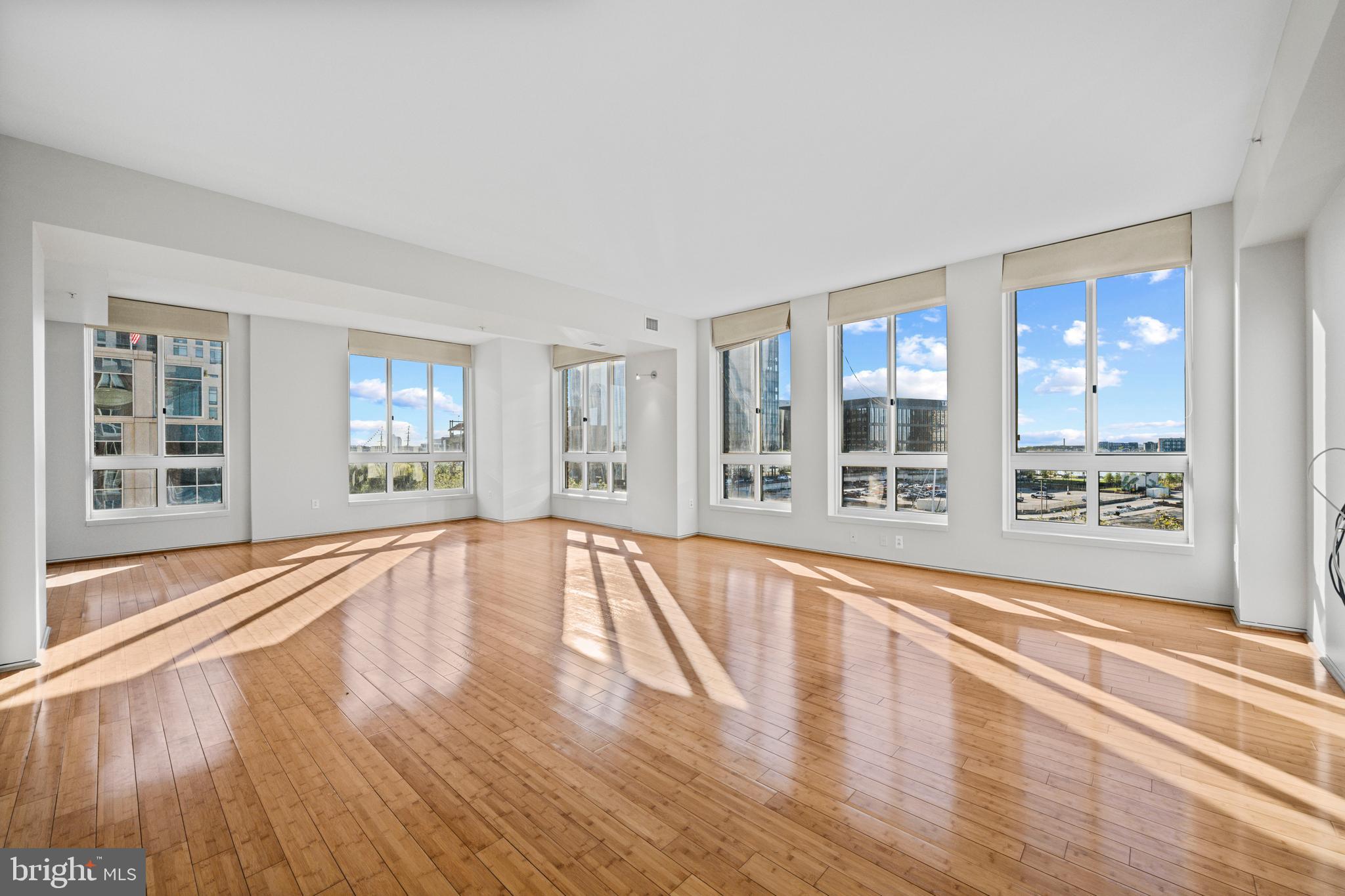717 President Street, Unit 504 Baltimore, MD 21202 - Photo 6 of 29 a view of an empty room with wooden floor and a window