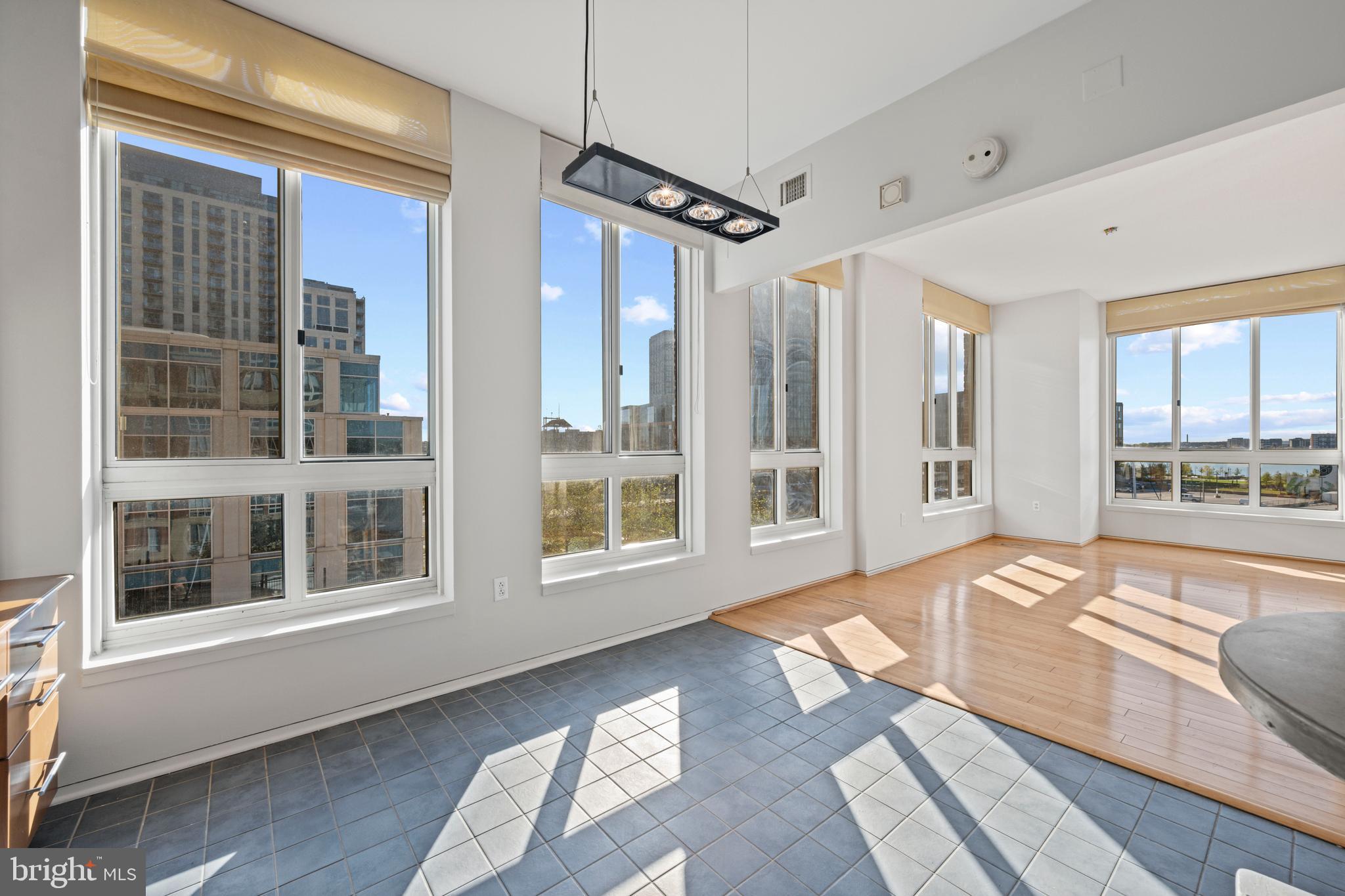 717 President Street, Unit 504 Baltimore, MD 21202 - Photo 8 of 29 a spacious bedroom with a large bed and windows