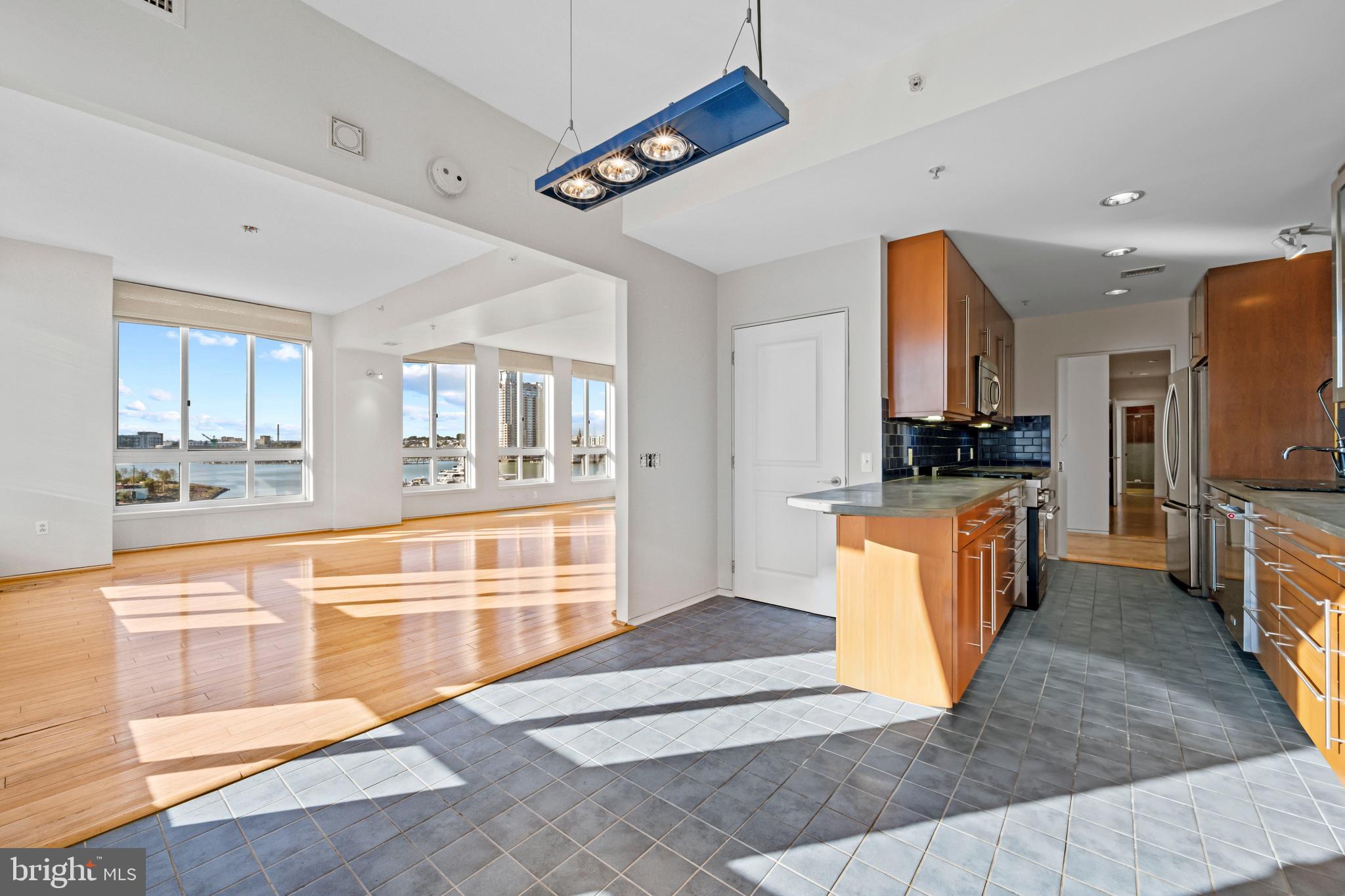 717 President Street, Unit 504 Baltimore, MD 21202 - Photo 10 of 29 a large kitchen with stainless steel appliances granite countertop a large counter top and a stove