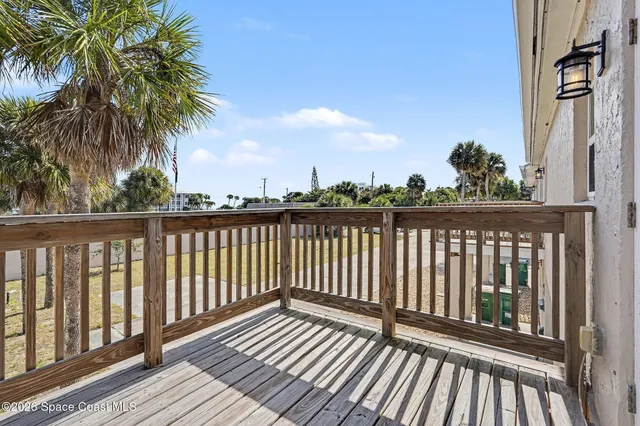 a view of a balcony with wooden floor