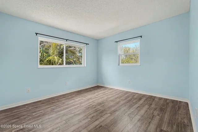 a view of room with window and wooden floor