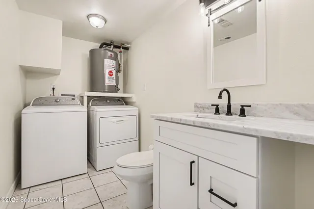 a bathroom with a sink toilet and mirror