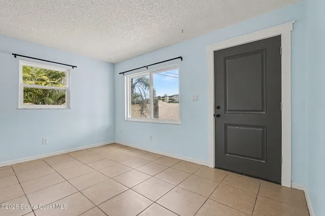 a view of an empty room with windows