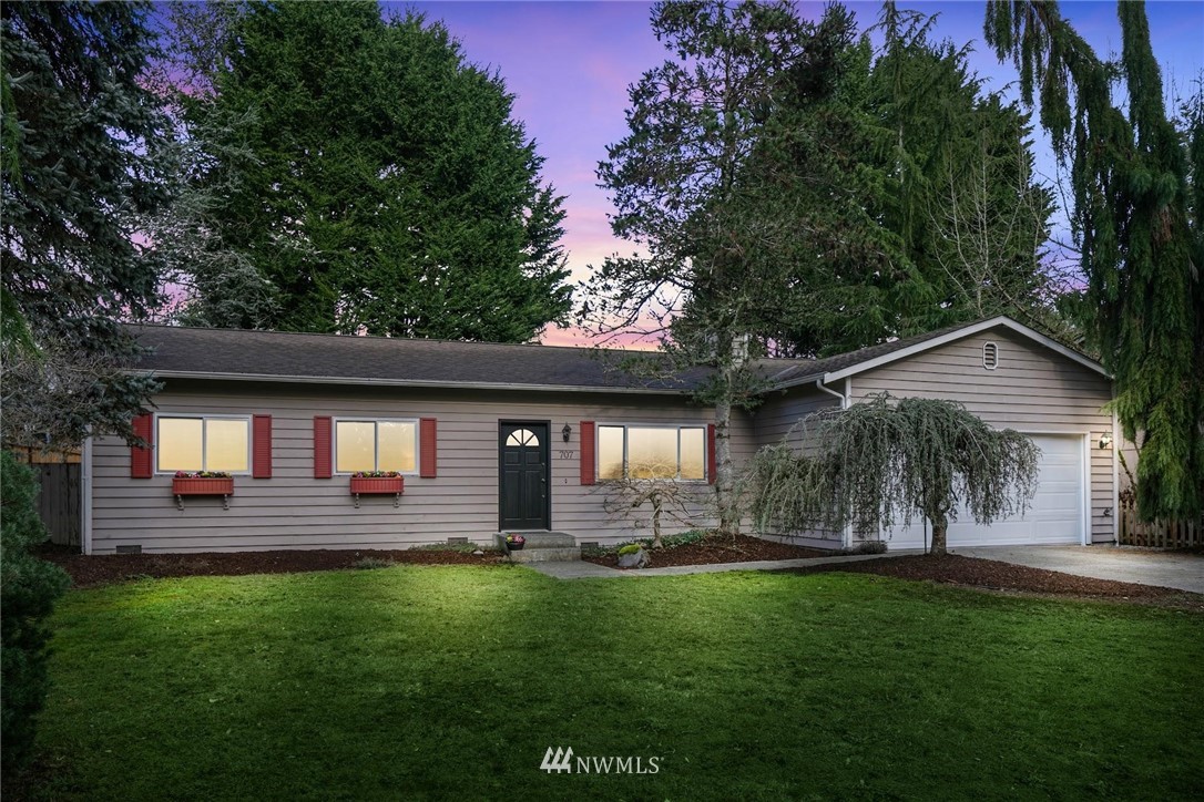 a front view of house with yard and outdoor seating
