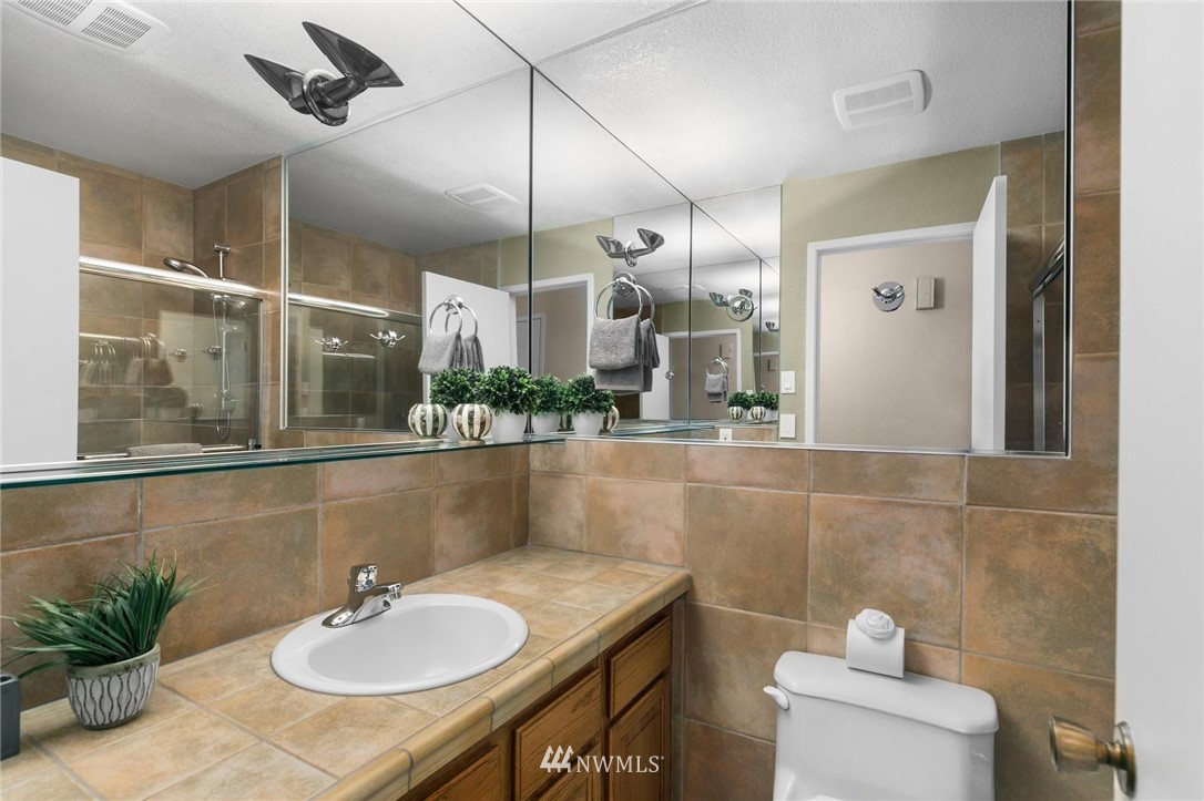 707 Harvest Road Bothell, WA 98012 - Photo 16 of 27 a bathroom with a sink and a mirror