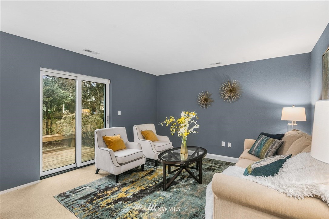 707 Harvest Road Bothell, WA 98012 - Photo 18 of 27 a living room with furniture and wooden floor