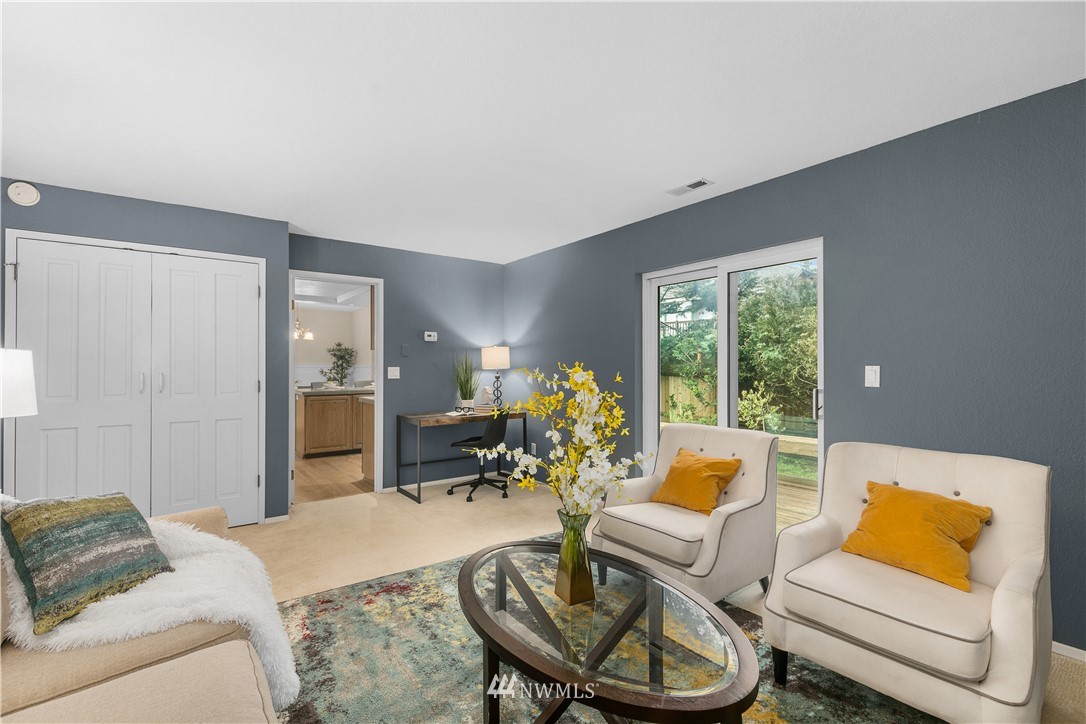 707 Harvest Road Bothell, WA 98012 - Photo 19 of 27 a living room with furniture and a large window