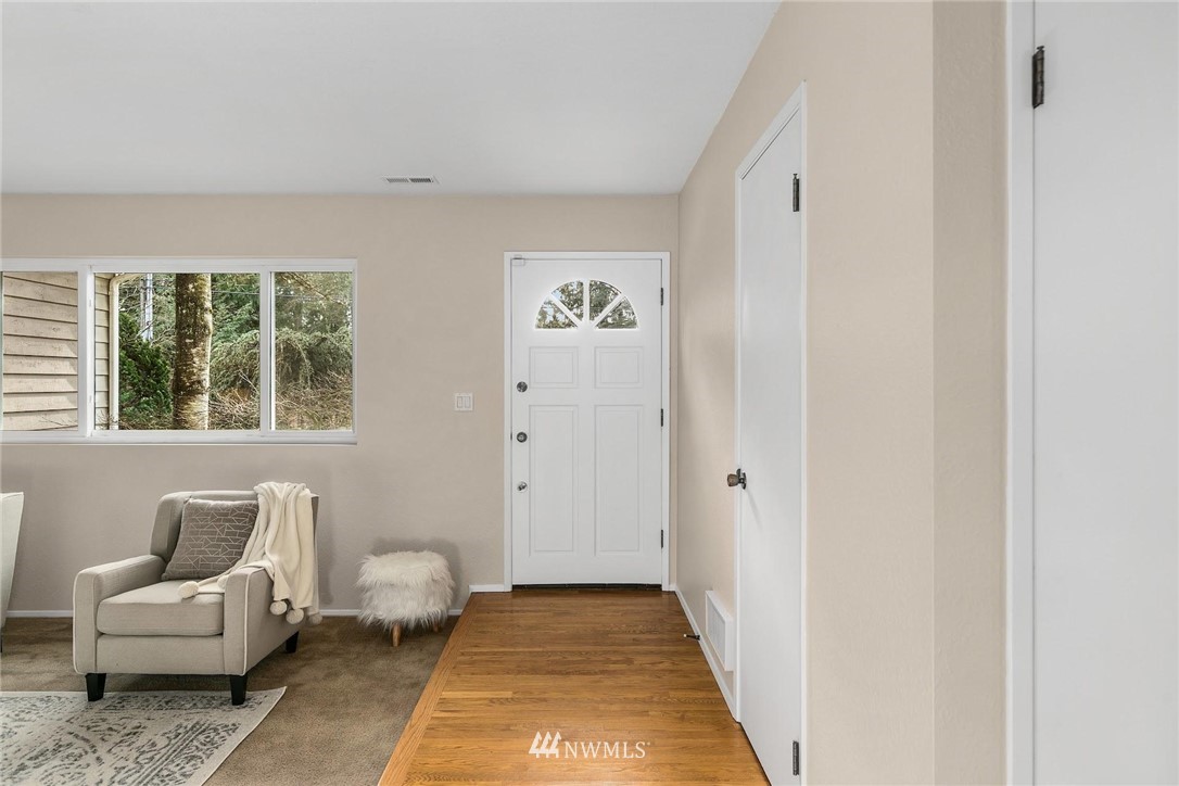 707 Harvest Road Bothell, WA 98012 - Photo 21 of 27 a hallway with a couch and a window