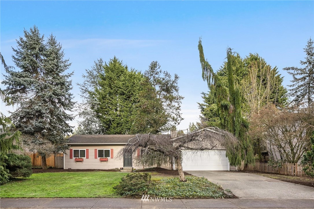 707 Harvest Road Bothell, WA 98012 - Photo 26 of 27 a front view of a house with a yard and trees