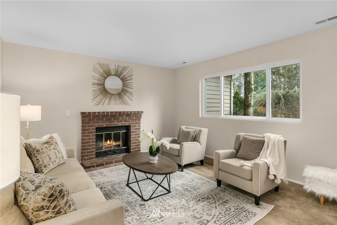 707 Harvest Road Bothell, WA 98012 - Photo 3 of 27 a living room with furniture and a fireplace