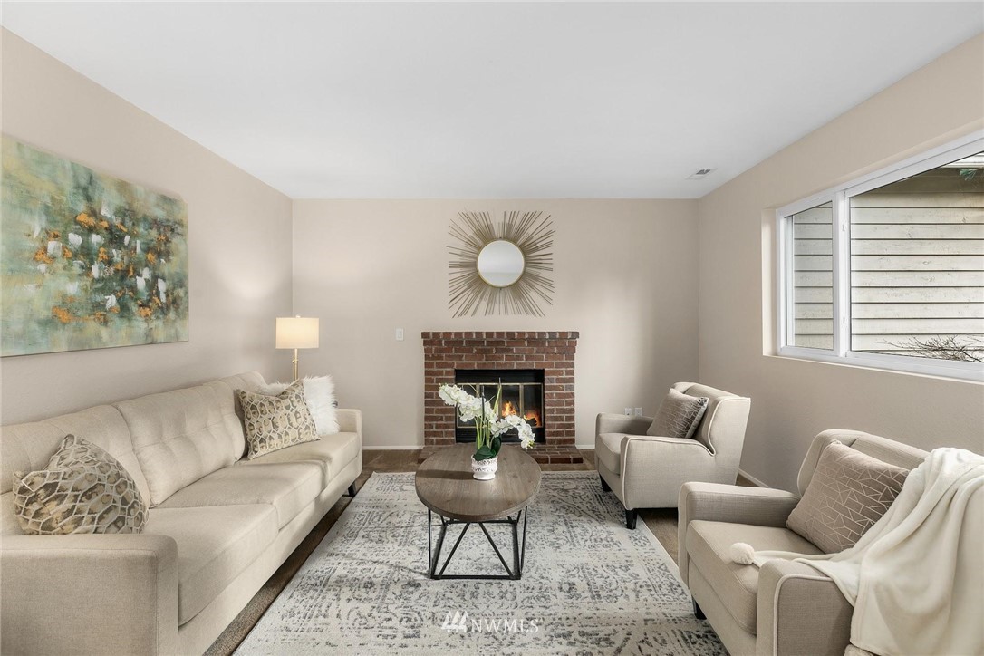 707 Harvest Road Bothell, WA 98012 - Photo 4 of 27 a living room with furniture a rug and a fireplace