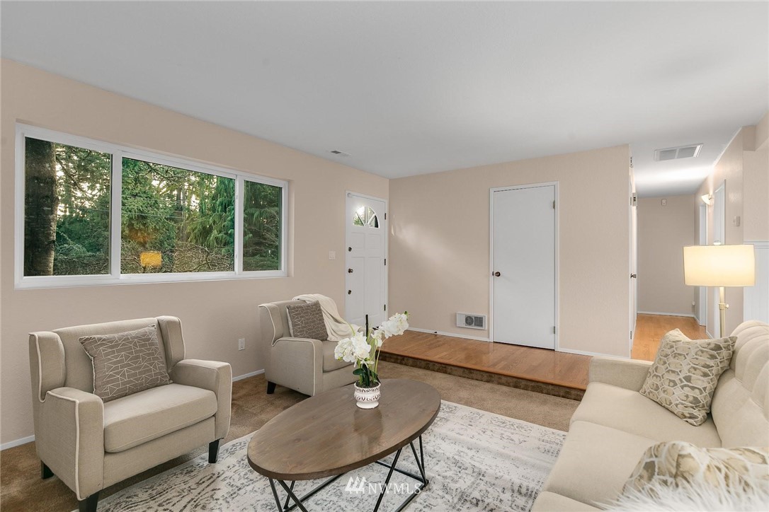 707 Harvest Road Bothell, WA 98012 - Photo 5 of 27 a living room with furniture and a large window