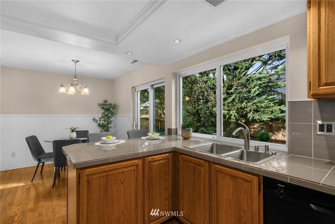 707 Harvest Road Bothell, WA 98012 - Photo 10 of 27 a kitchen with a sink and large window