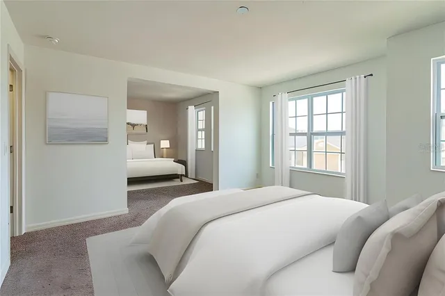 a bedroom with a bed and a large mirror