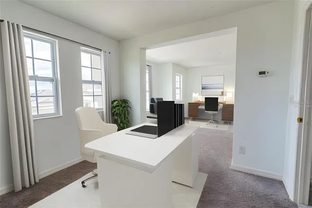 a view of kitchen with furniture and windows