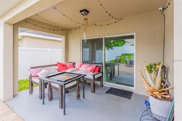 a view of a patio with table and chairs potted plants with wooden fence